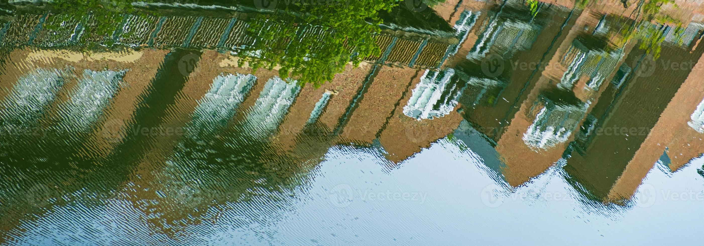 Reflection of Traditional buildings in the waters of River Wear in Durham, England photo