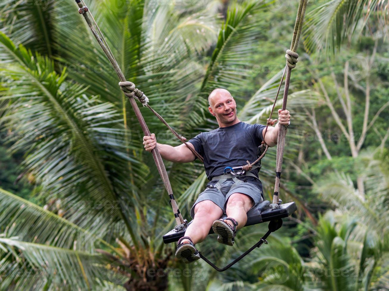 Caucasian man having fun at Bali swing photo