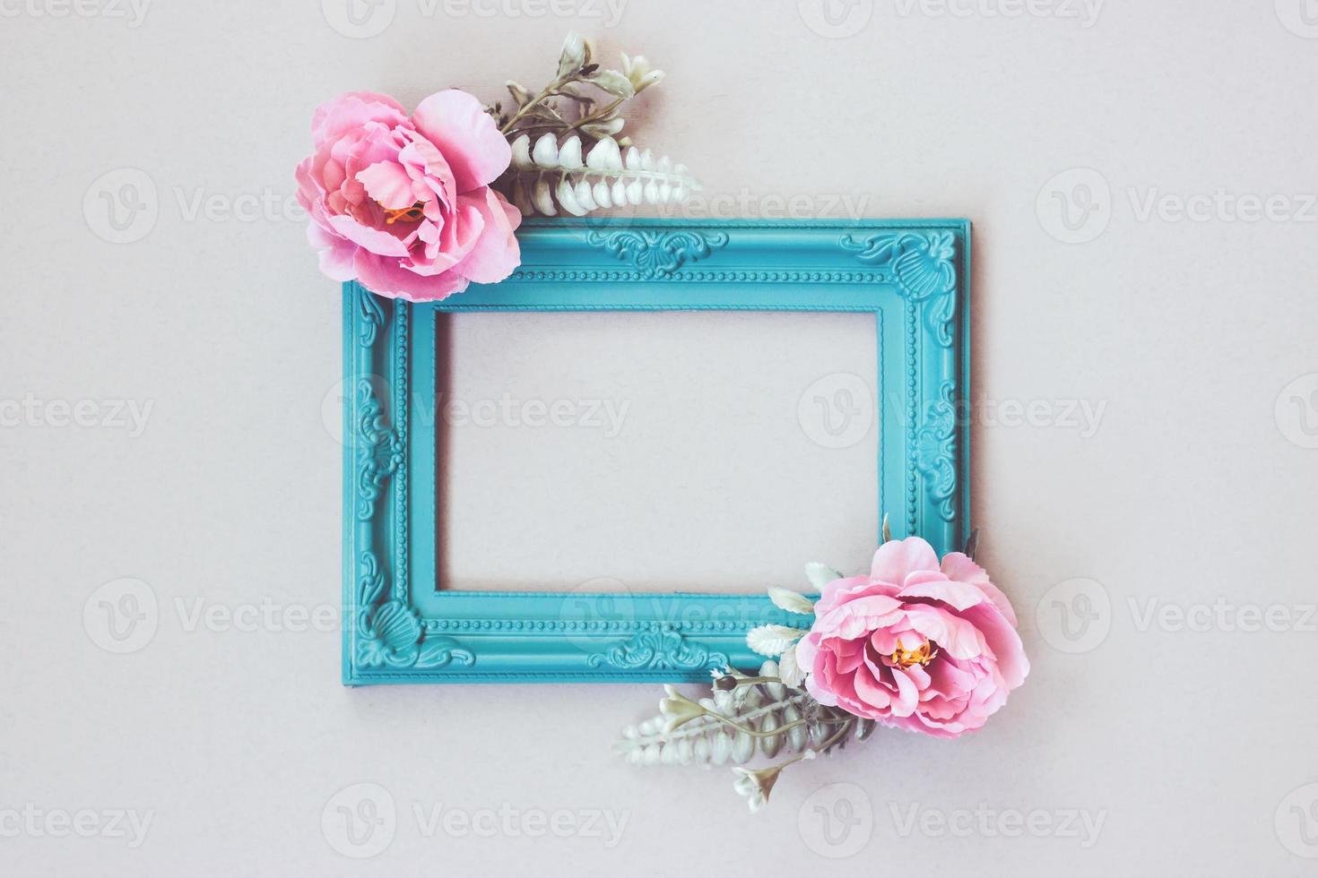 Composition made of decorative picture frame and pastel colored flowers with copy space photo