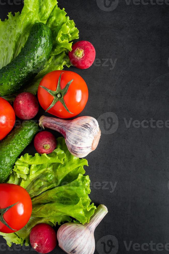 Fresh vegetables on a dark background. The concept of healthy nutrition and diet. photo