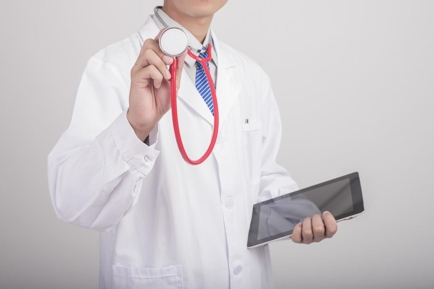 Medicine doctor hand holding stethoscope and working with modern medical icons photo