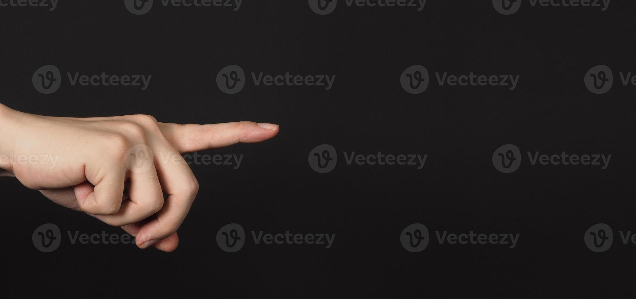 Index finger pointing and isolated on black background photo