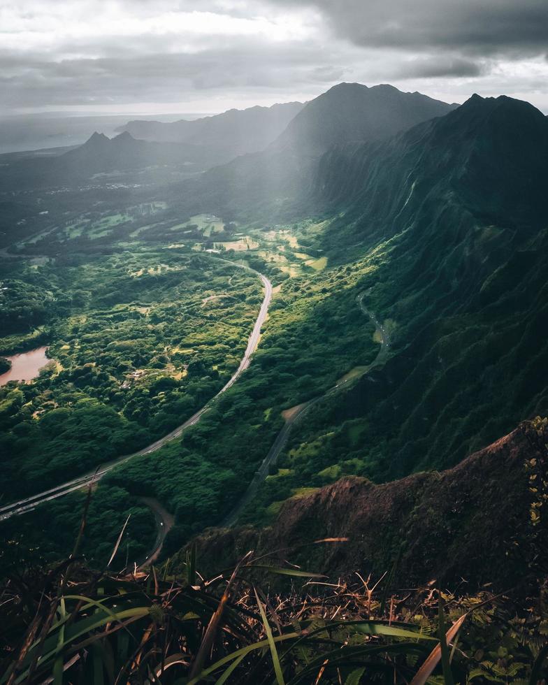 Tropical nature view of a highway from a hiking trail in Oahu, Hawaii photo