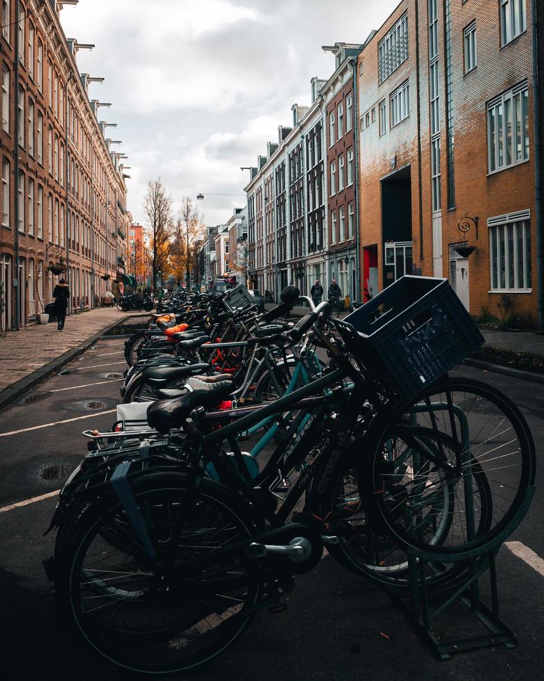 Amsterdam, Netherlands 2018- A row of bicycles parked in the street in Amsterdam photo