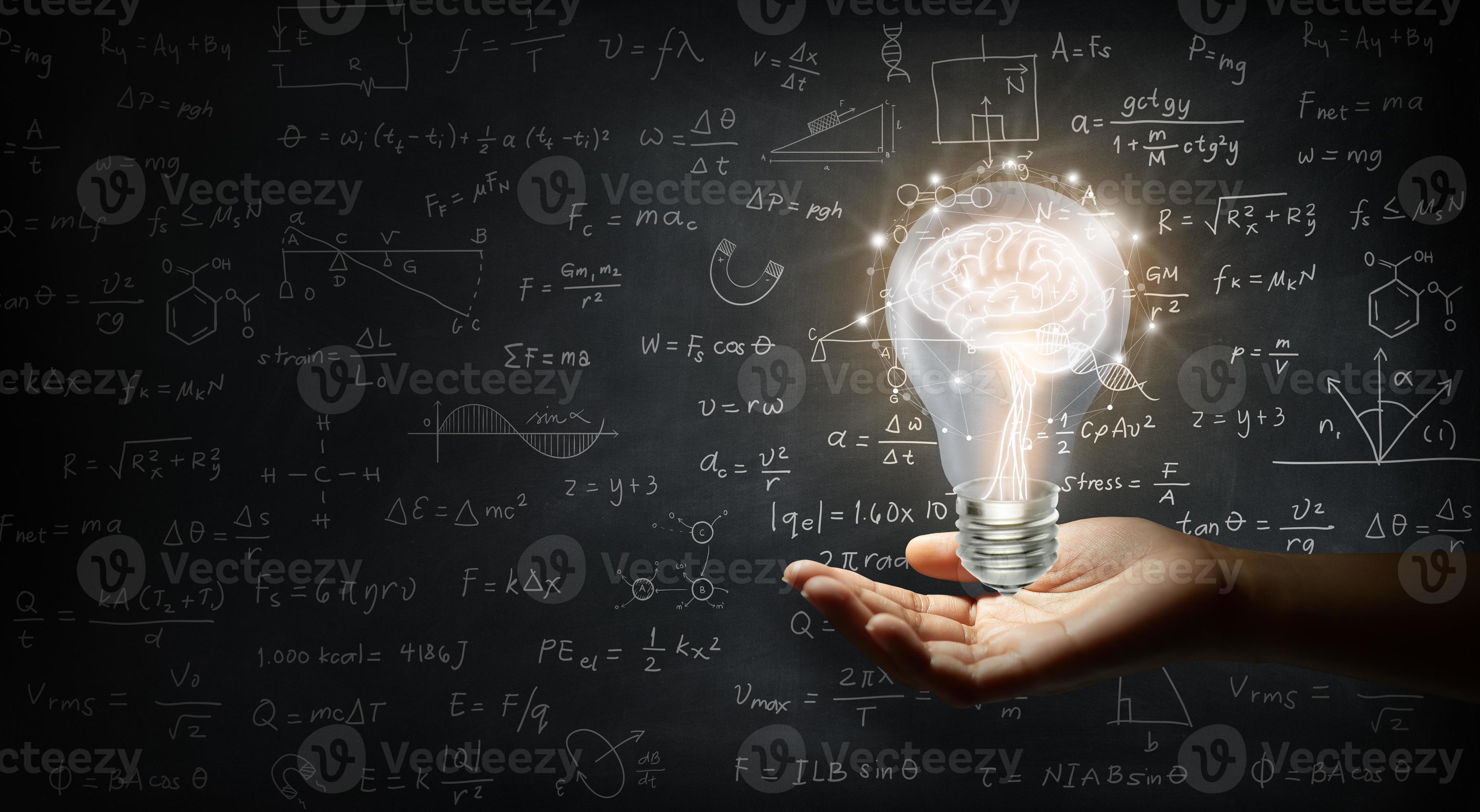 Hand holding a brain inside a light bulb on wall blackboard 2646081 Stock Photo at Vecteezy