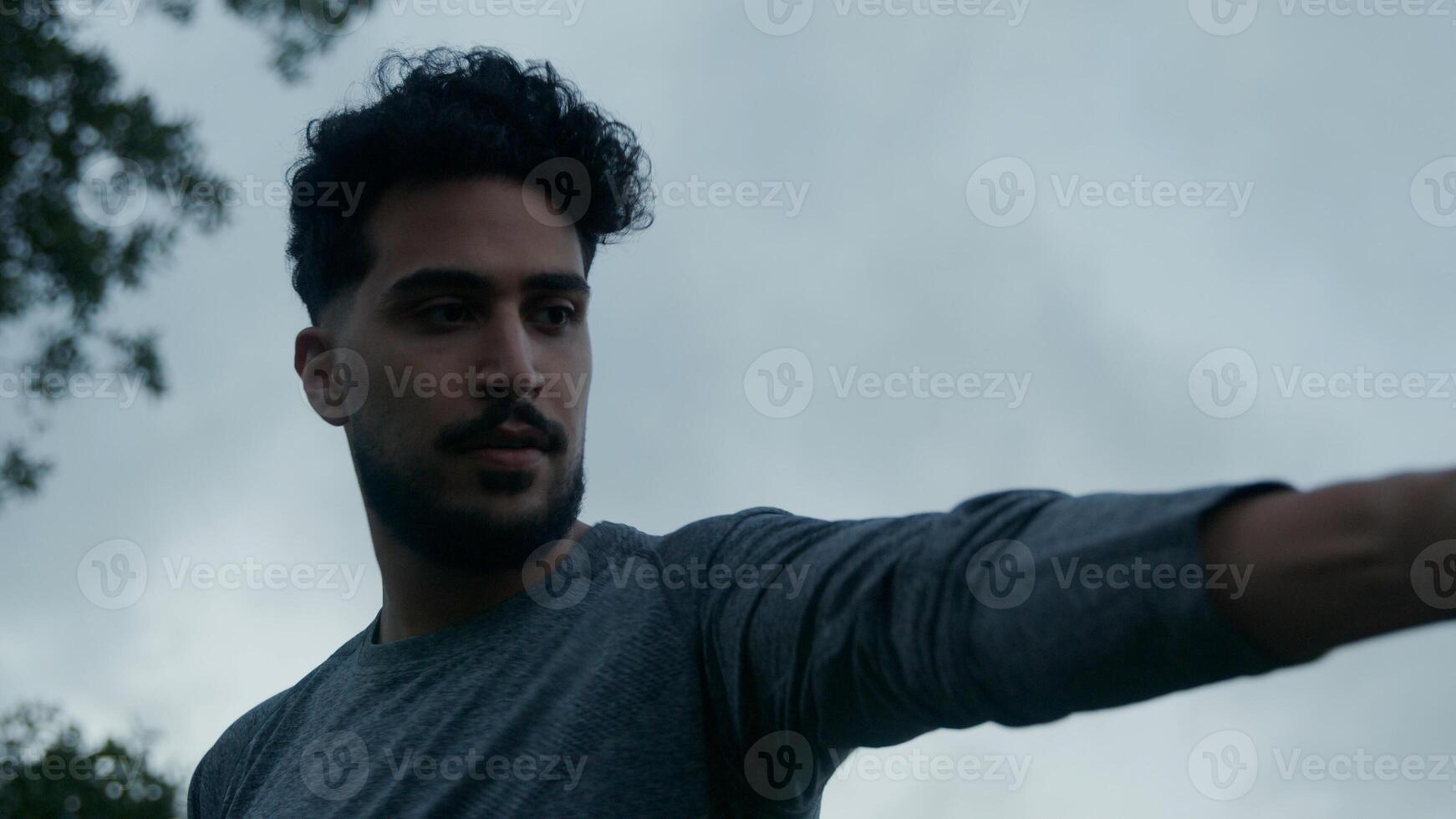 Portrait of young man using punching ball photo