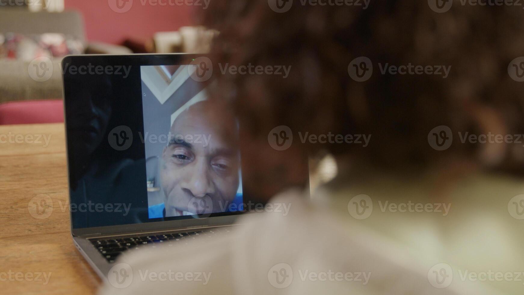 Mature man on laptop screen during online meeting photo