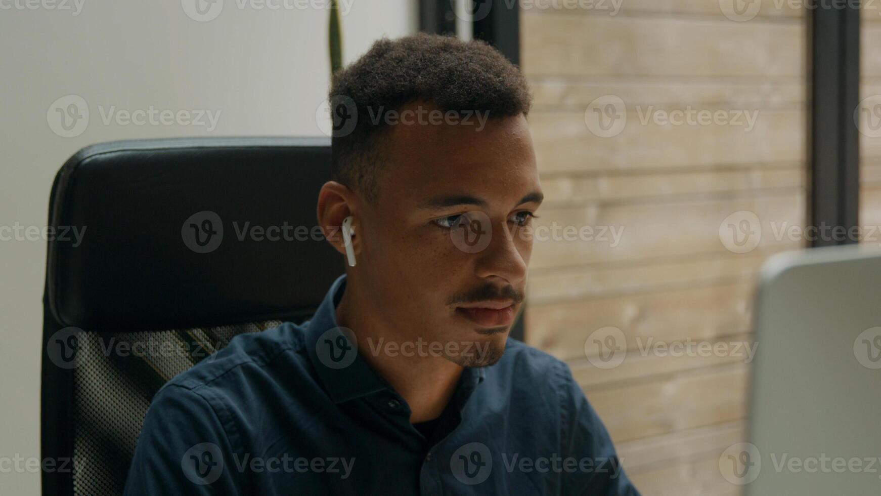 Tilt up of young man using computer mouse and keyboard photo