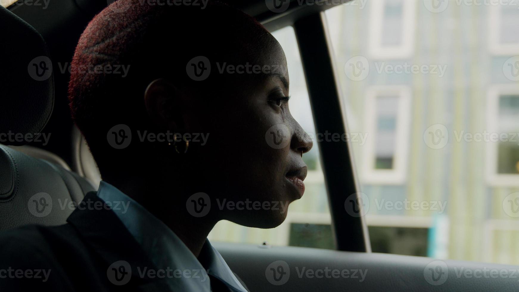 Young businesswoman sitting in back of cab photo