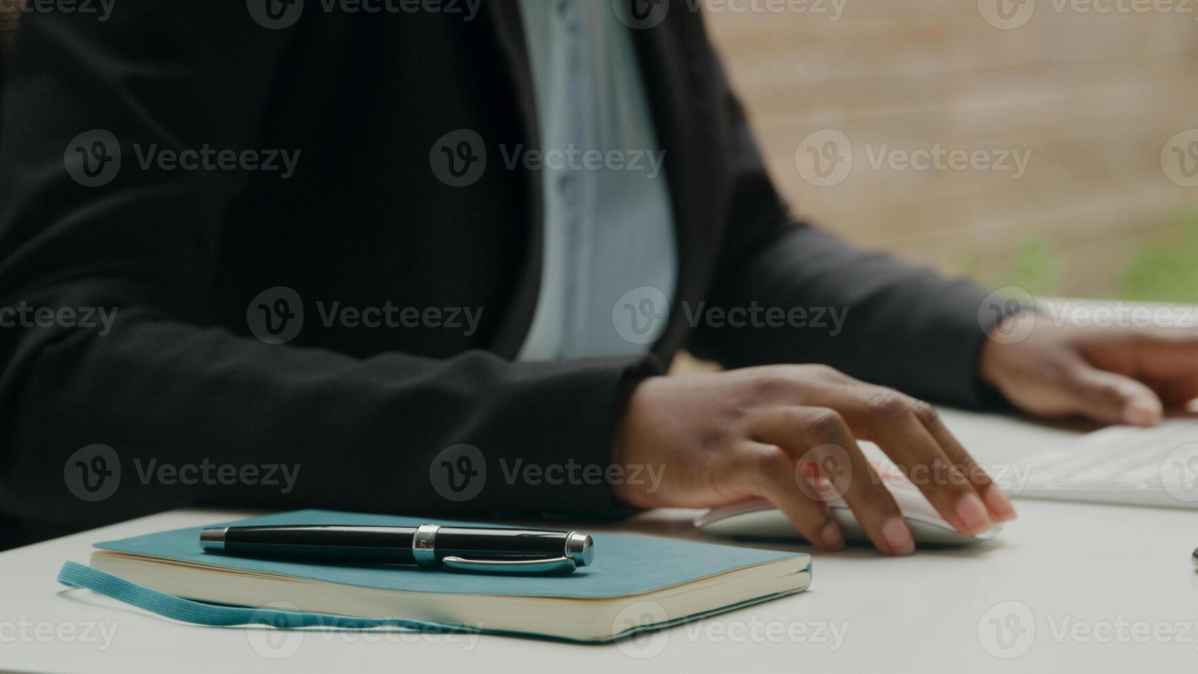 Close up of woman working with computer keyboard and pen photo