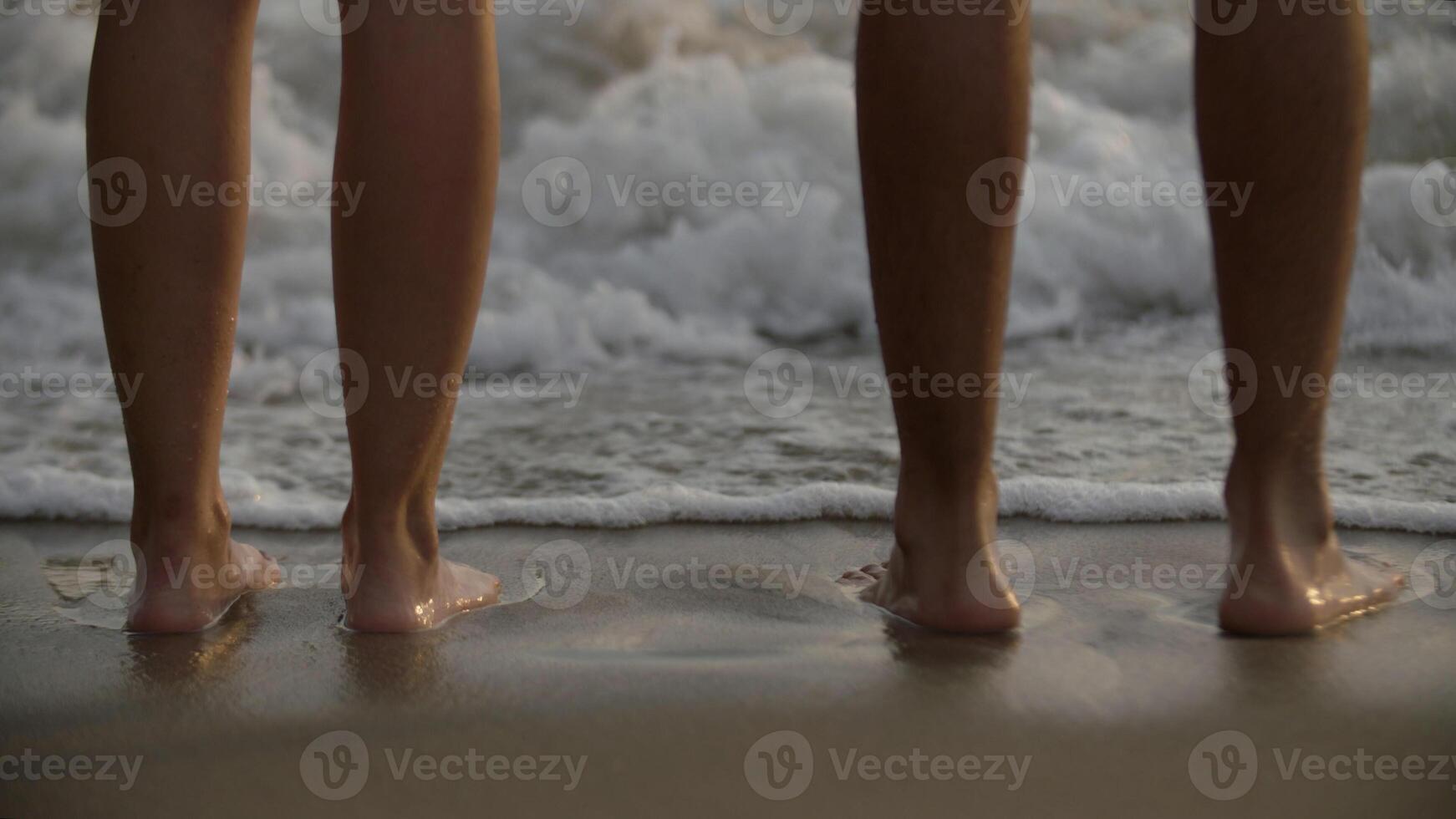 Couple standing at sea shore photo