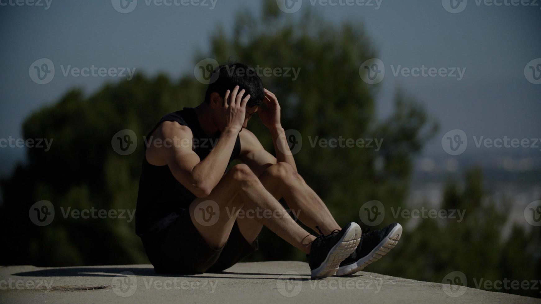 Portrait of mid adult man doing crunches photo