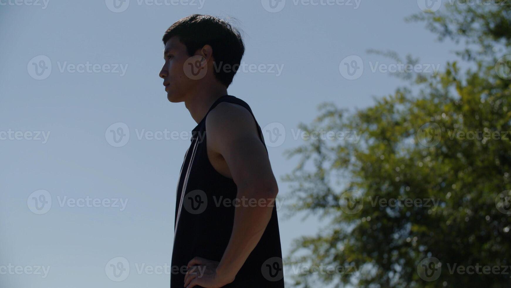 Tilt up of man in sports clothing standing outdoors photo