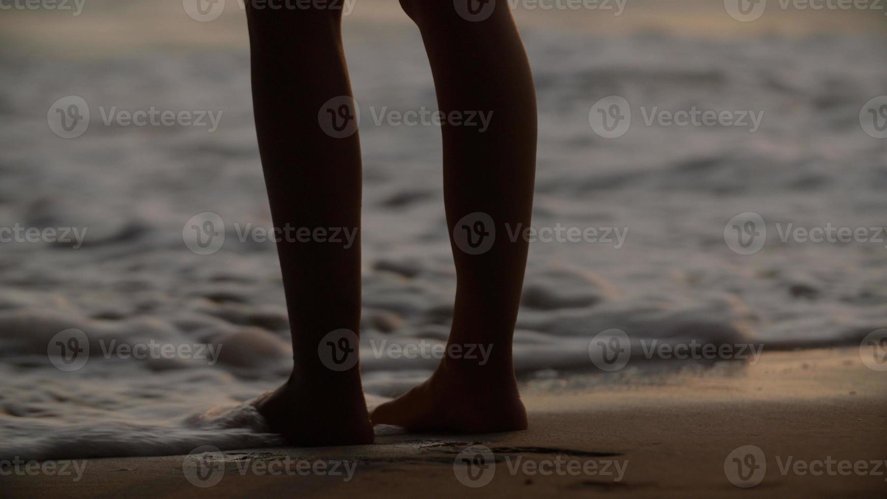 Person standing at sea shore photo