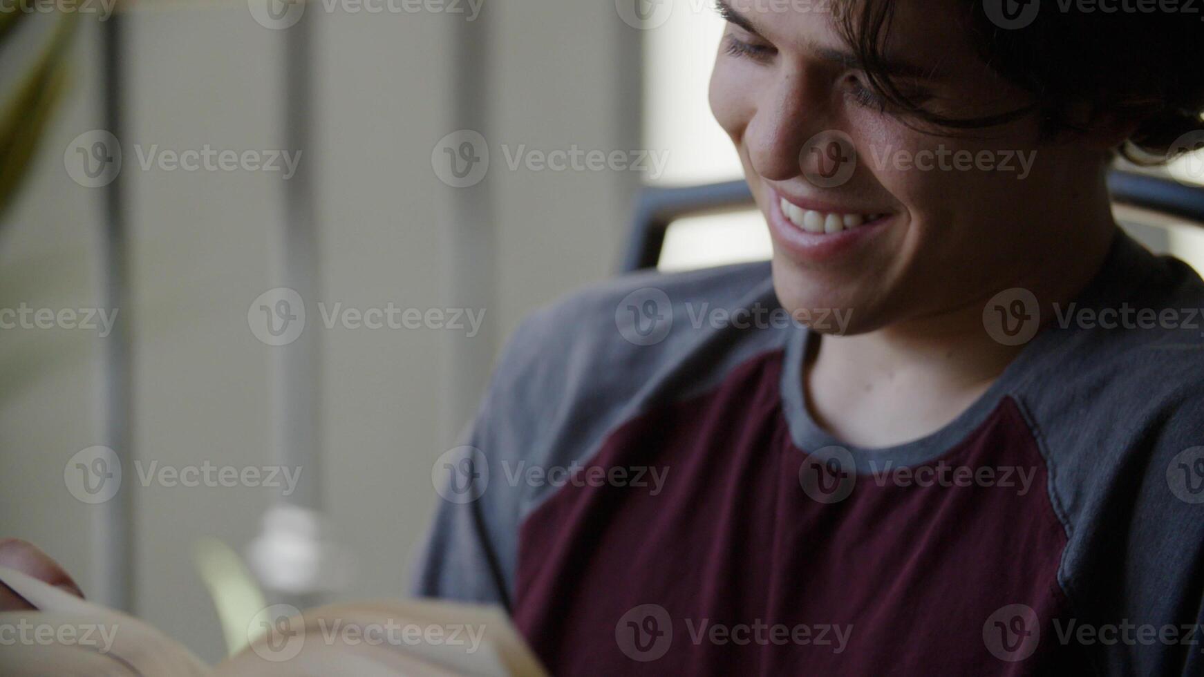 Portrait of young man reading book smiling photo