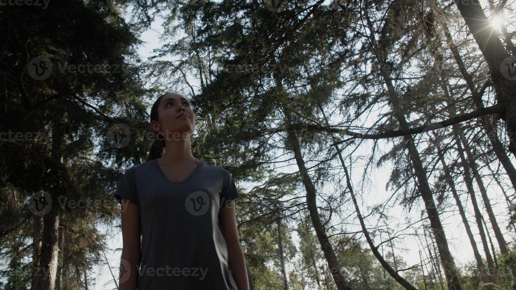 Portrait of young woman walking through woods photo