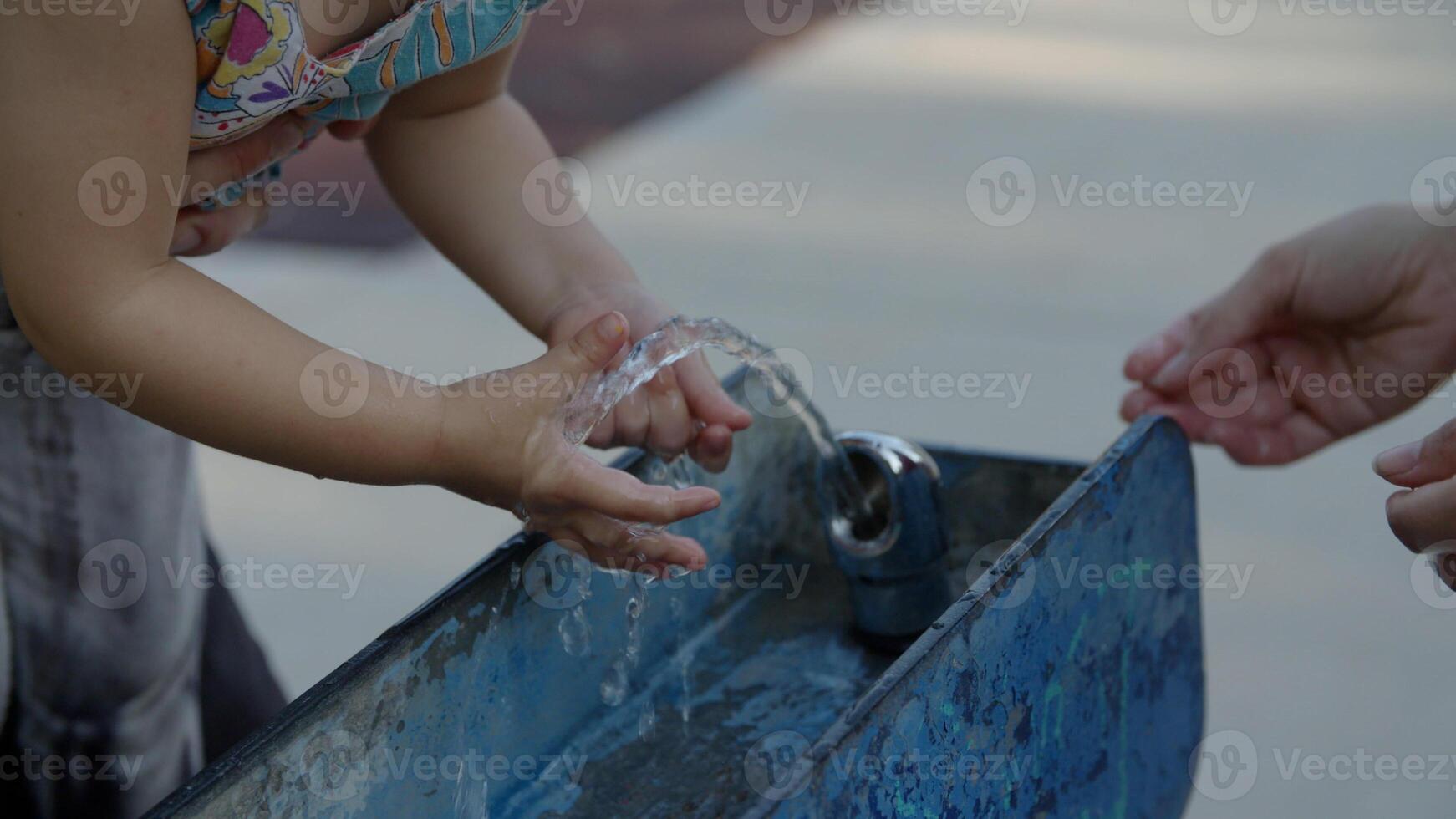 Portrait of girl touching water in fountain photo