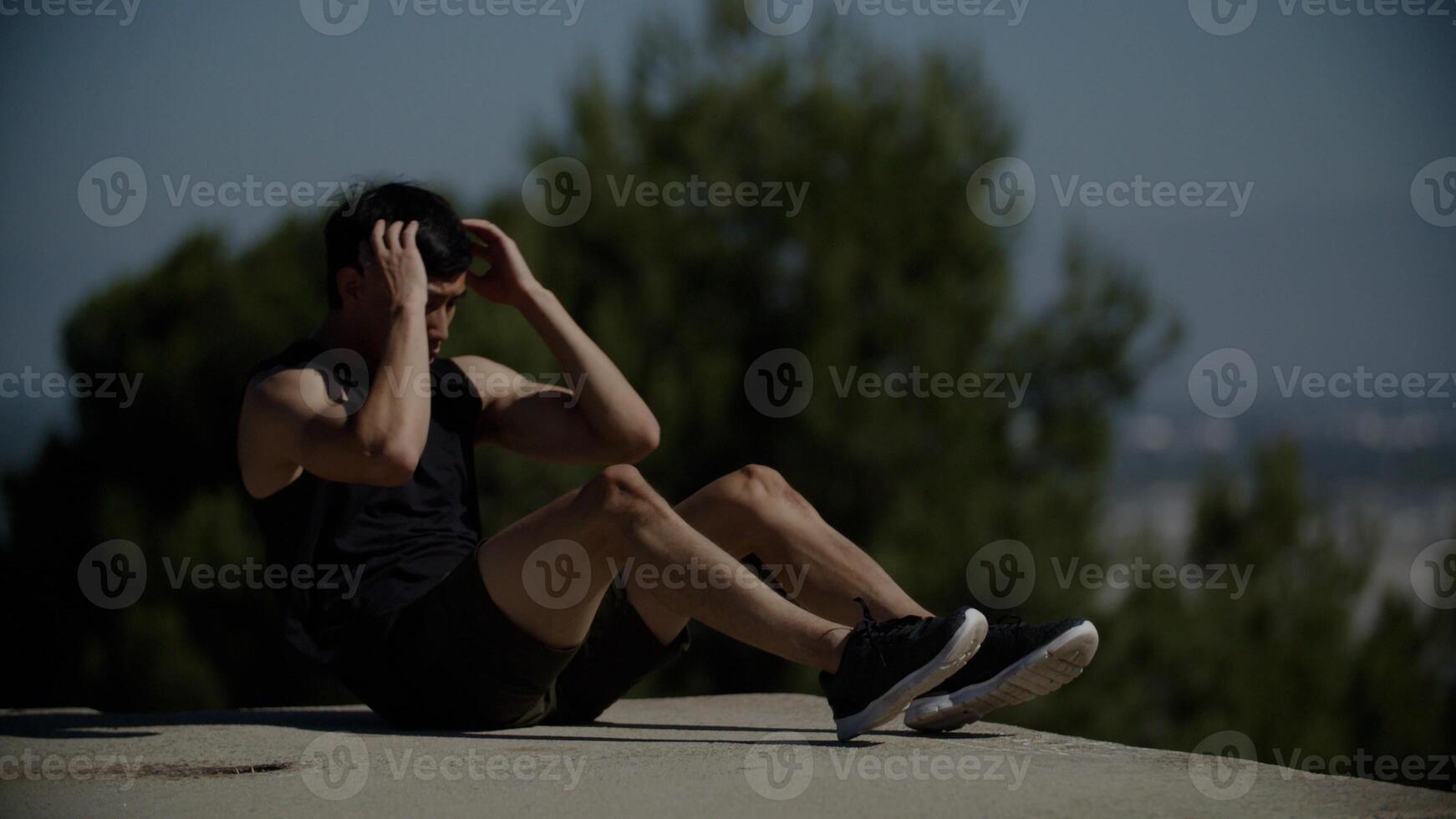 Portrait of mid adult man doing crunches photo