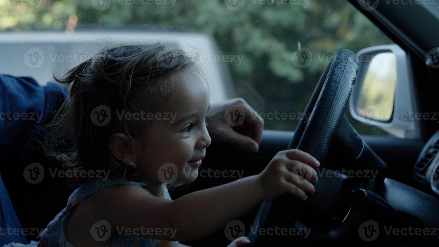 Portrait of girl playing with steering wheel photo