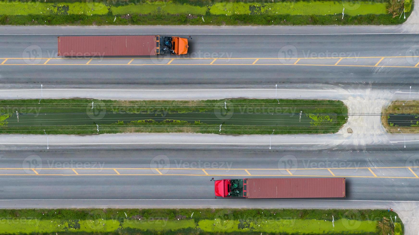 Aerial top view of trucks on road and highway photo