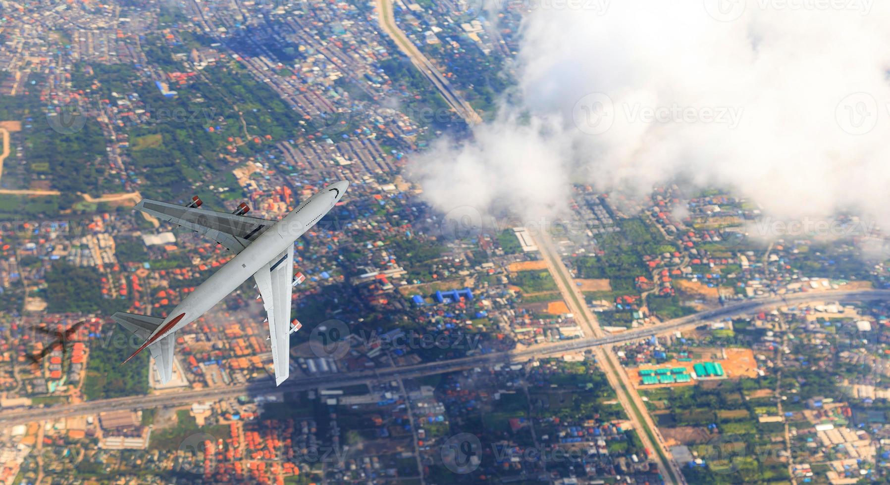 Aerial top view of Airplane flies over the city, view from above photo