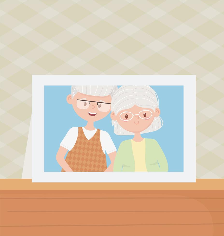 ancianos, linda pareja abuelos marco de fotos en la mesa vector