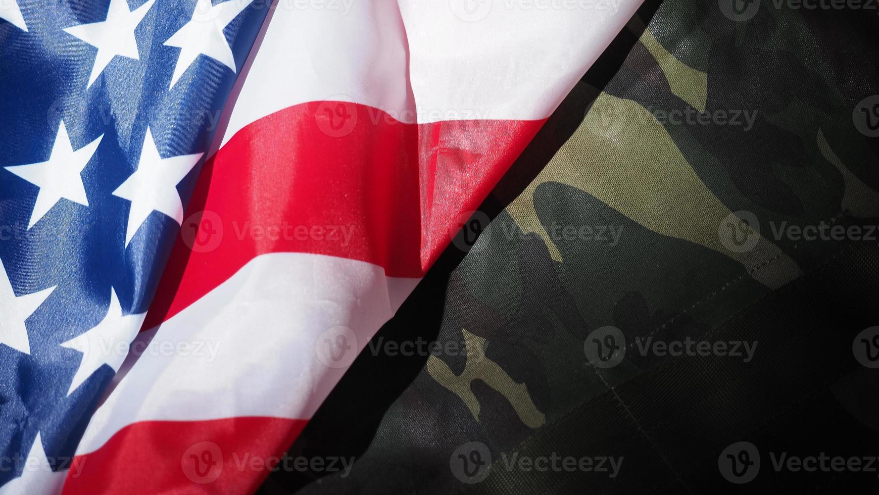 Military hat or bag laying with american flag. photo