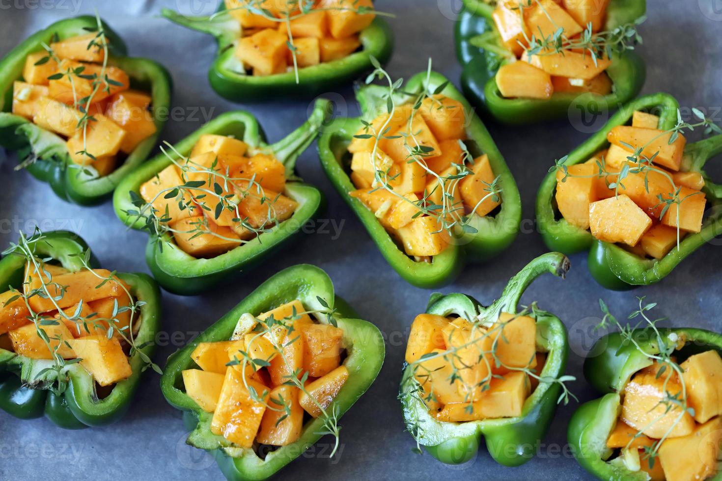 Green peppers stuffed with pumpkin pieces photo