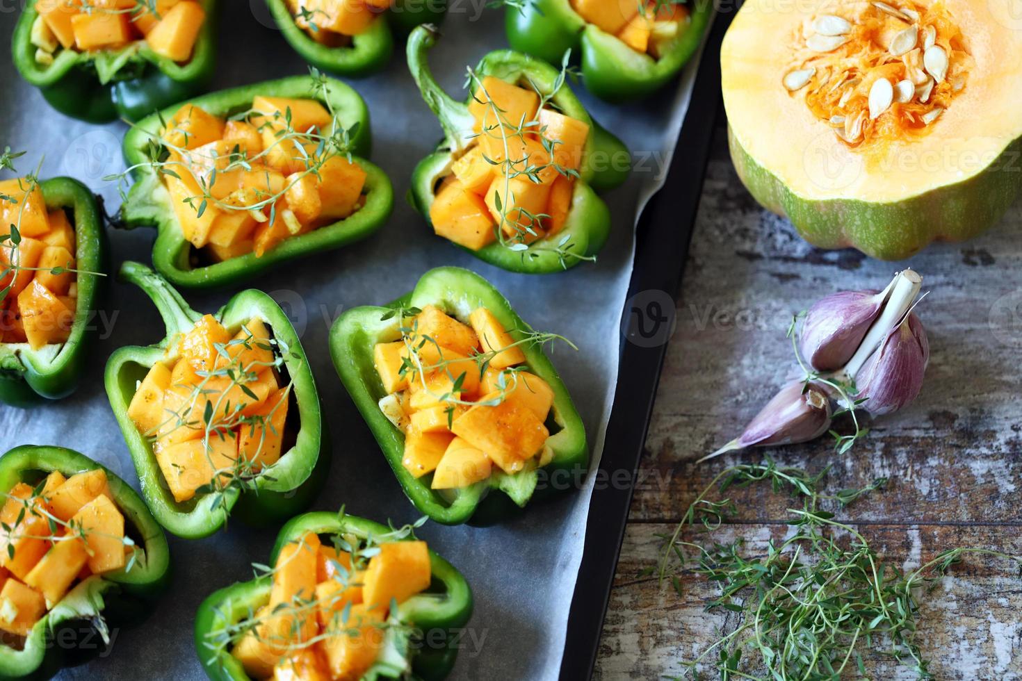 Green peppers stuffed with pumpkin pieces photo