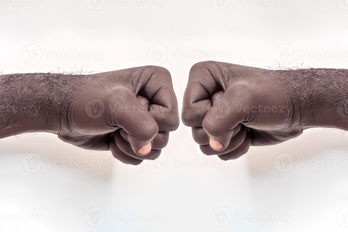 Male hand clenched into a fist on a white background. A symbol of the struggle for the rights of blacks in America. Protest against racism. photo