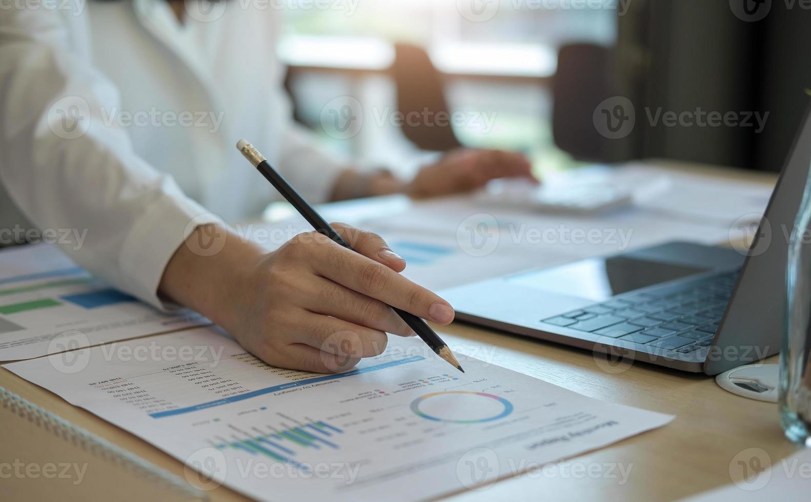 Close up Businessman using calculator and laptop for calaulating finance, tax, accounting, statistics and analytic research concept photo