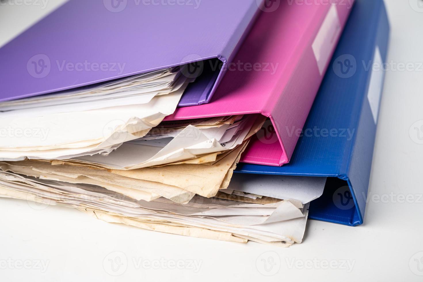 File Folder Binder stack of multi color on table in office. photo