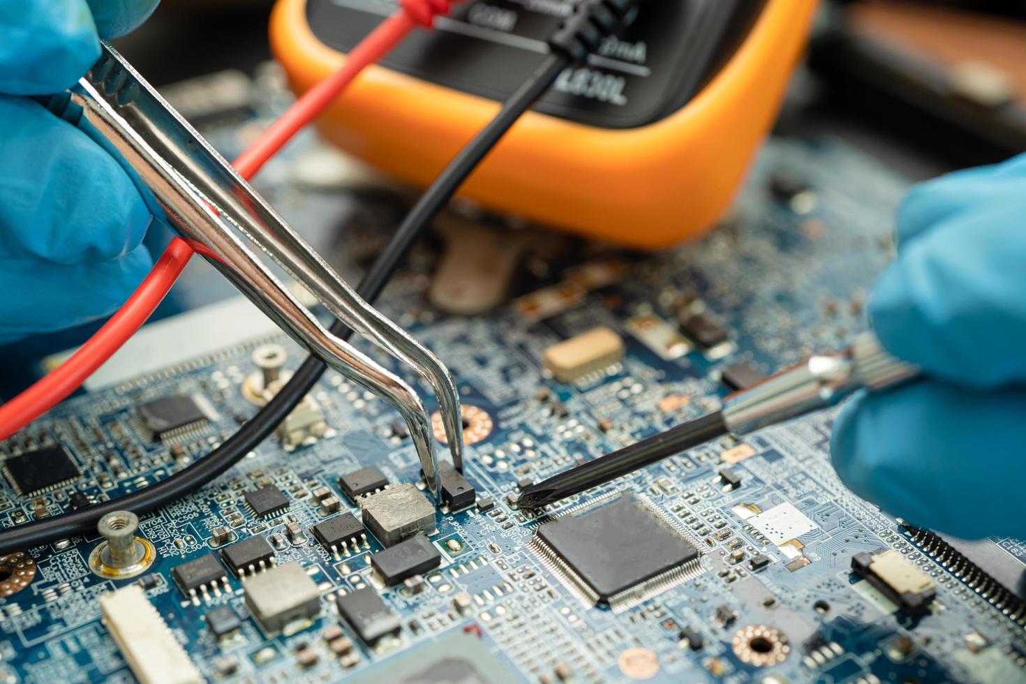 technician repairing inside of hard disk by soldering iron. Integrated Circuit. the concept of data, hardware, technician and technology. photo