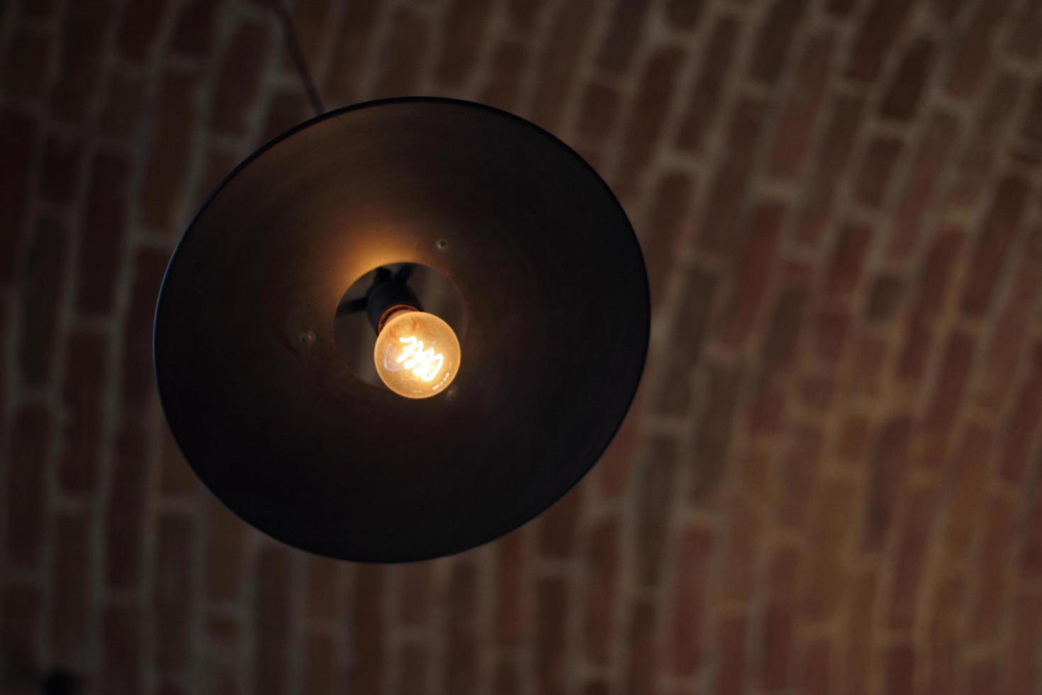 round hanging lamp on brick ceiling photo