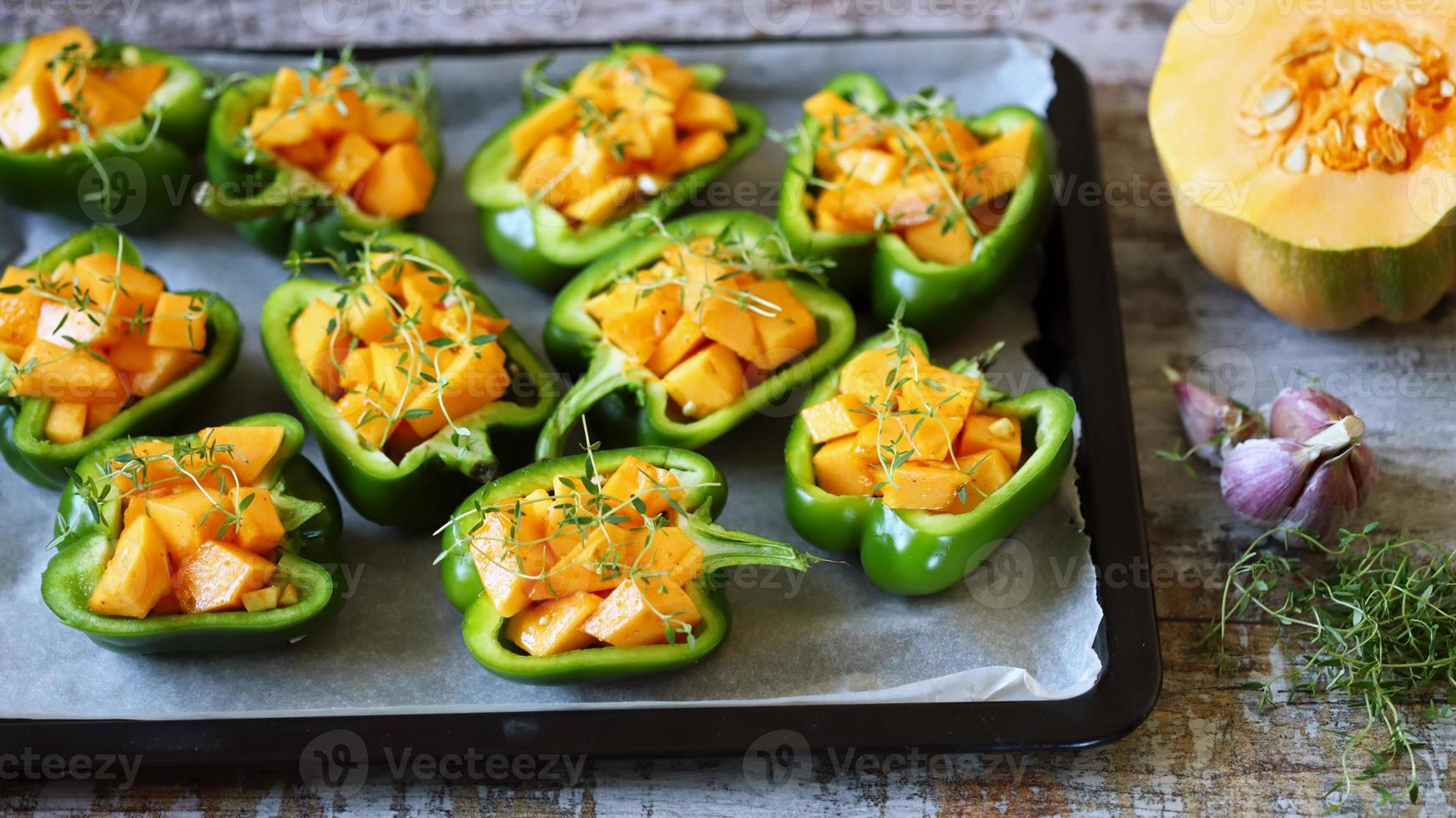 Green peppers stuffed with pumpkin pieces photo