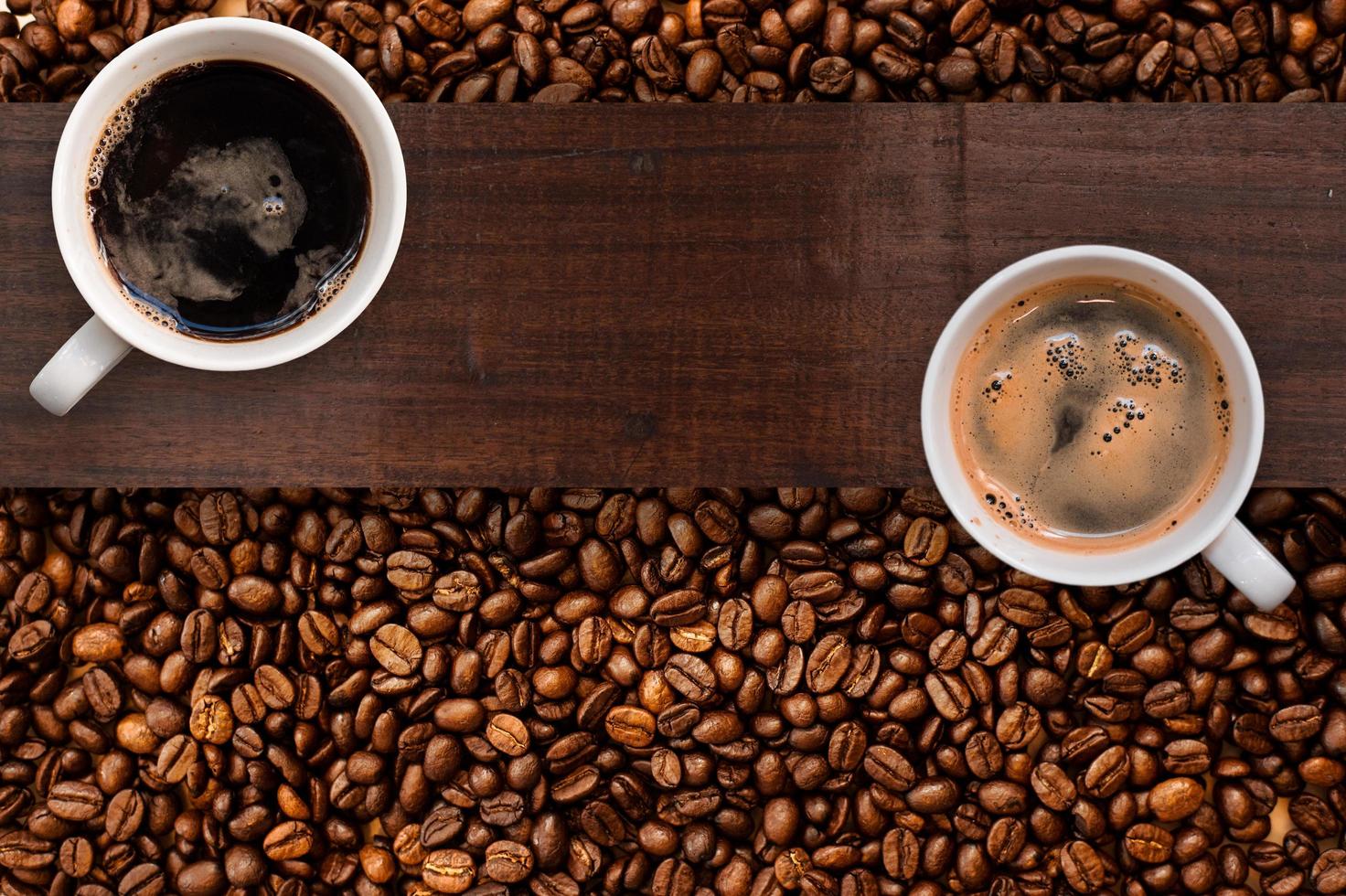 Cup of coffee with coffee beans on table photo