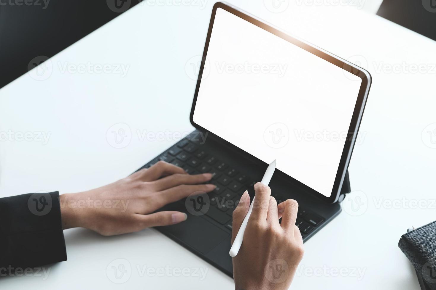 Business Women use a tablet for work, a blank tablet screen can add text or other media. photo