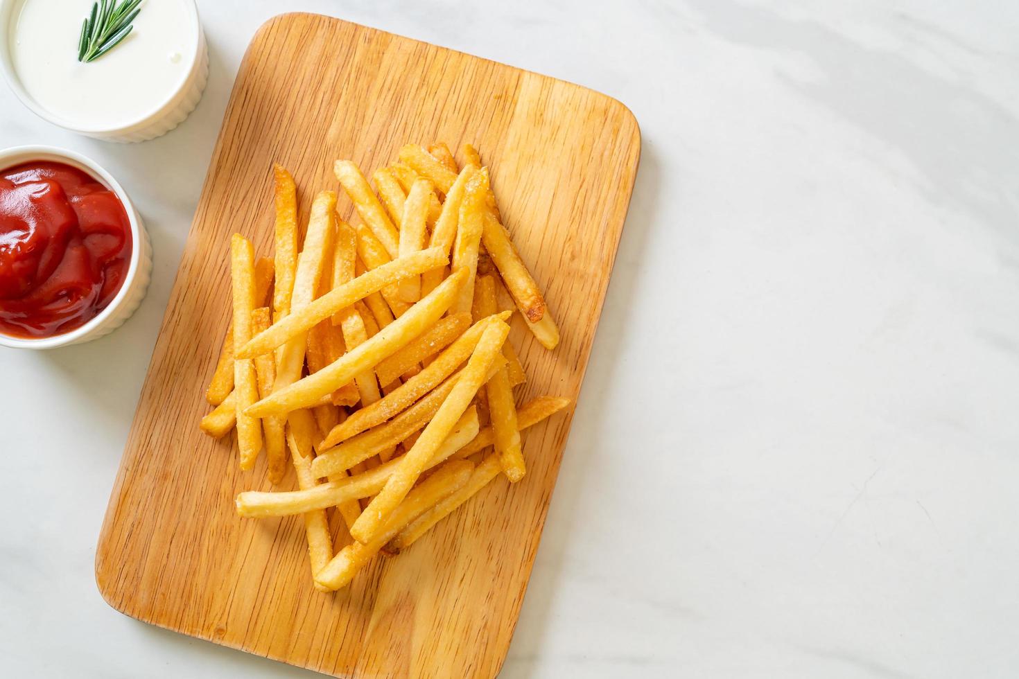 French fries with sour cream and ketchup photo