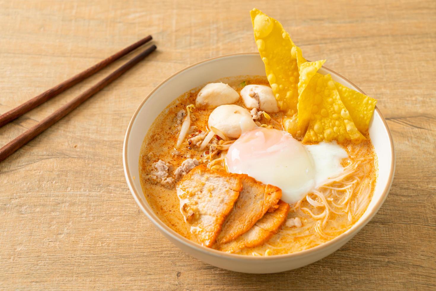 Rice vermicelli noodles with meatball, roasted pork and egg in spicy