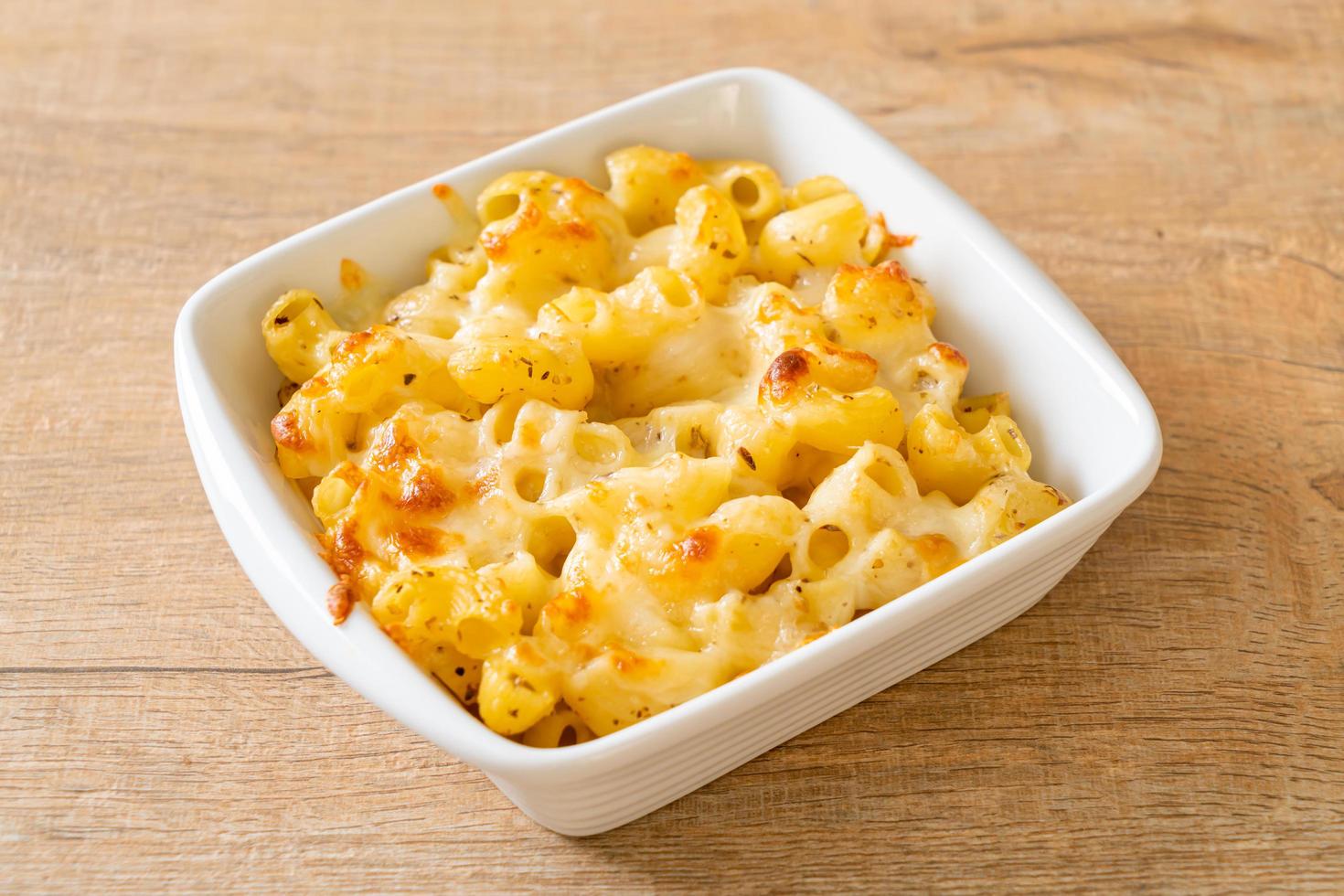 American mac and cheese, macaroni pasta in cheesy sauce photo