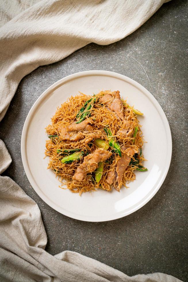 Stir fried rice vermicelli noodle with black soy sauce and pork photo