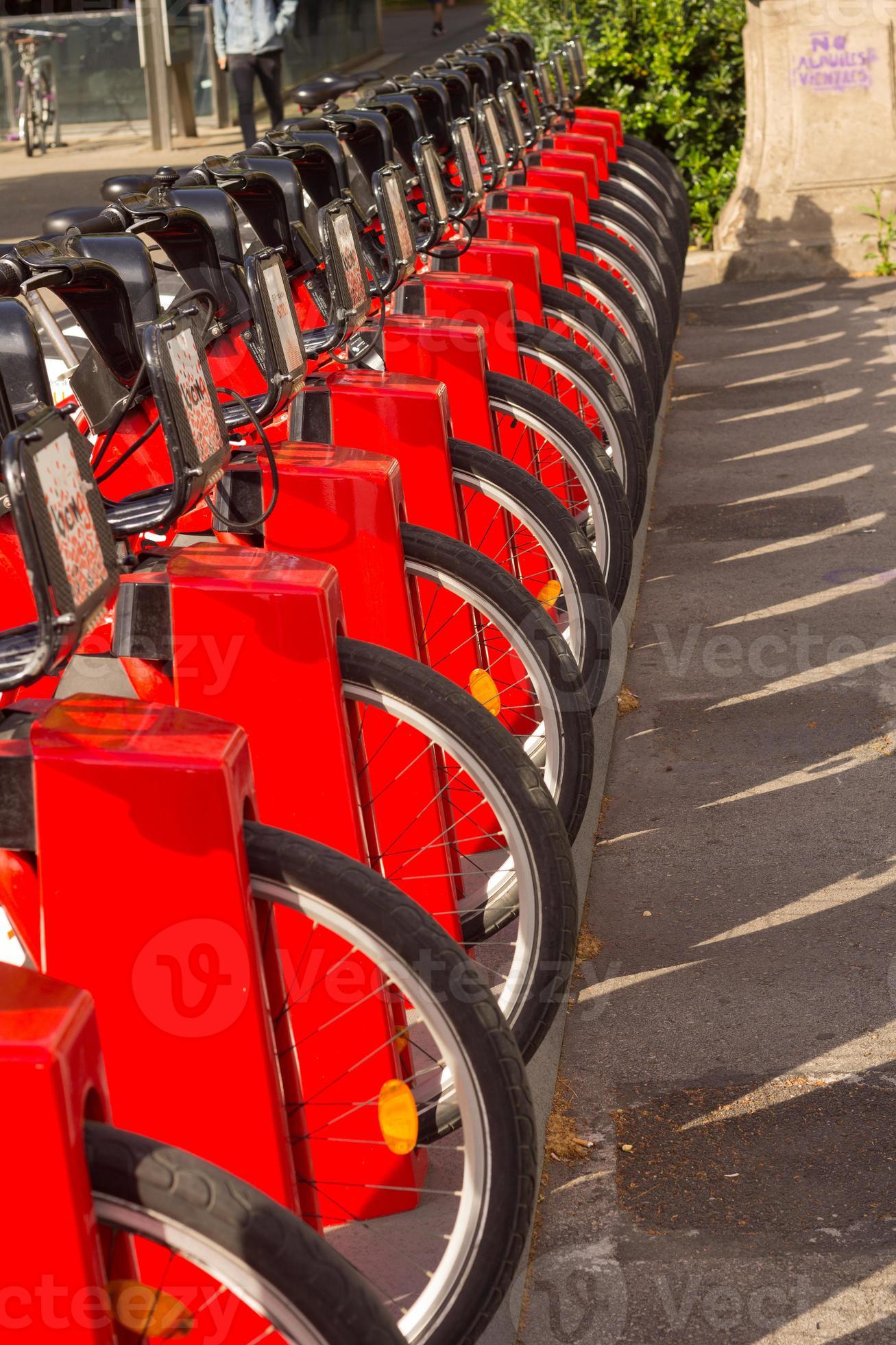 Bicycle rental service on city road parking with sunlight, public