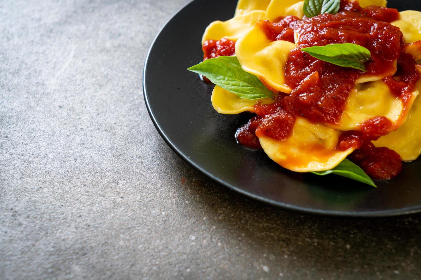 Ravioli with tomato sauce and basil photo