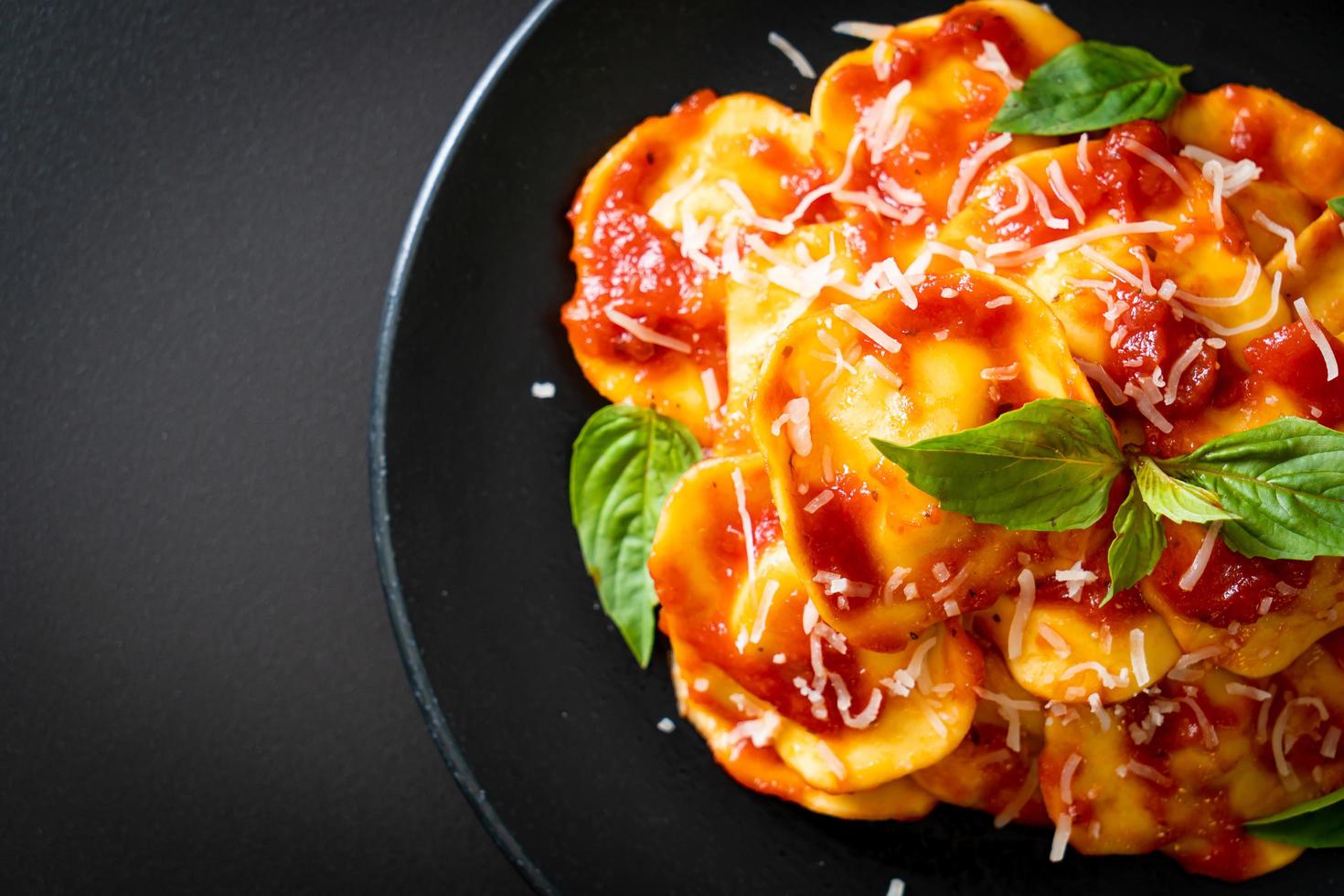 Ravioli with tomato sauce and basil photo