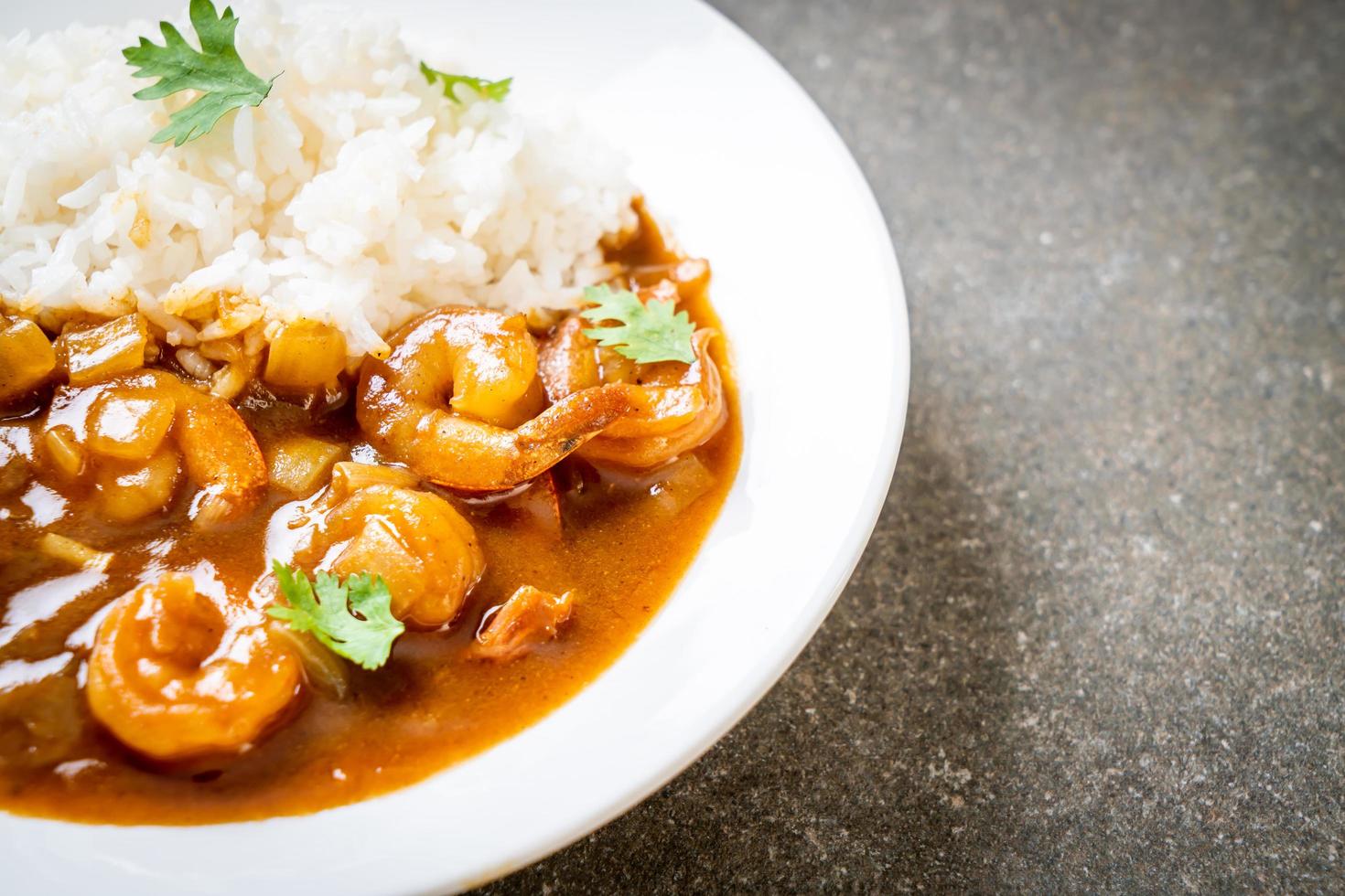 Shrimps in curry sauce on rice photo