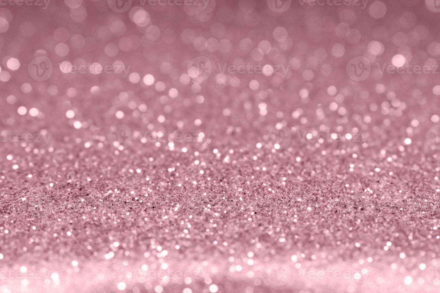 Rose gold festive glitter background. Shallow depth of field, blurred bokeh effect photo