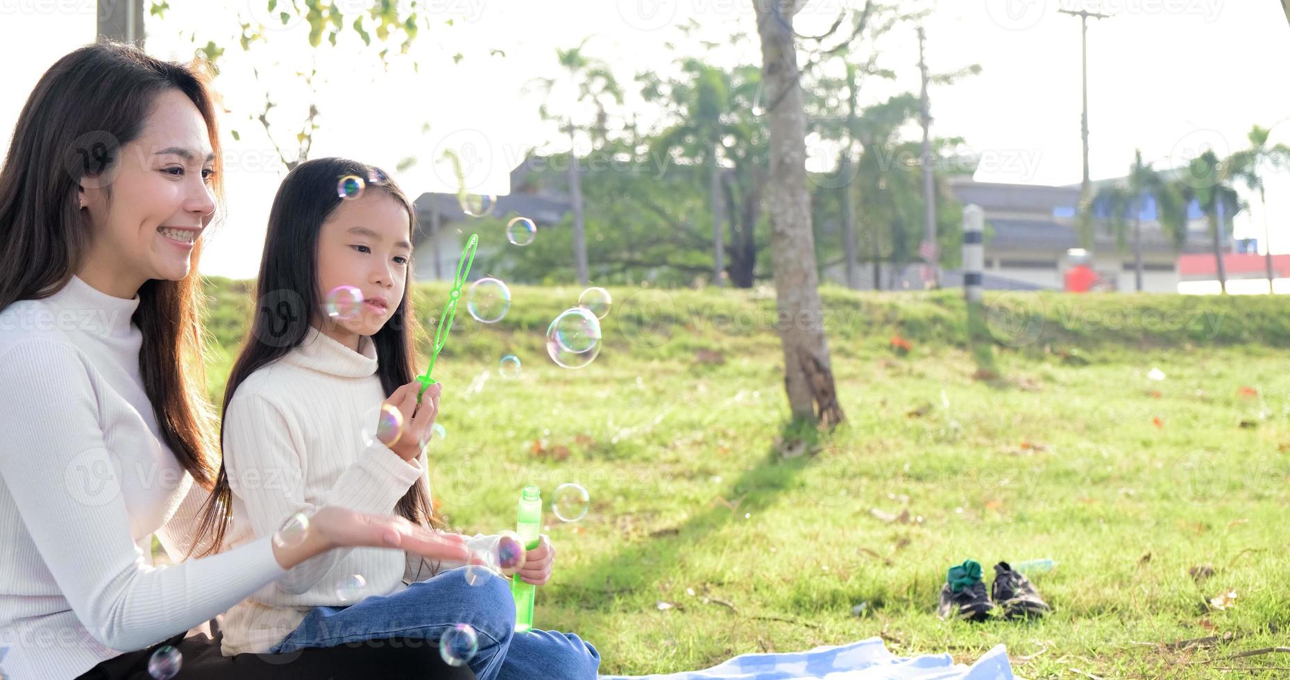 Asian portrait family trip father mother and daughter enjoy relaxation Blowing bubbles with family to lifestyle freedom family vacation caucasian asian.one day trip new normol togetherness photo