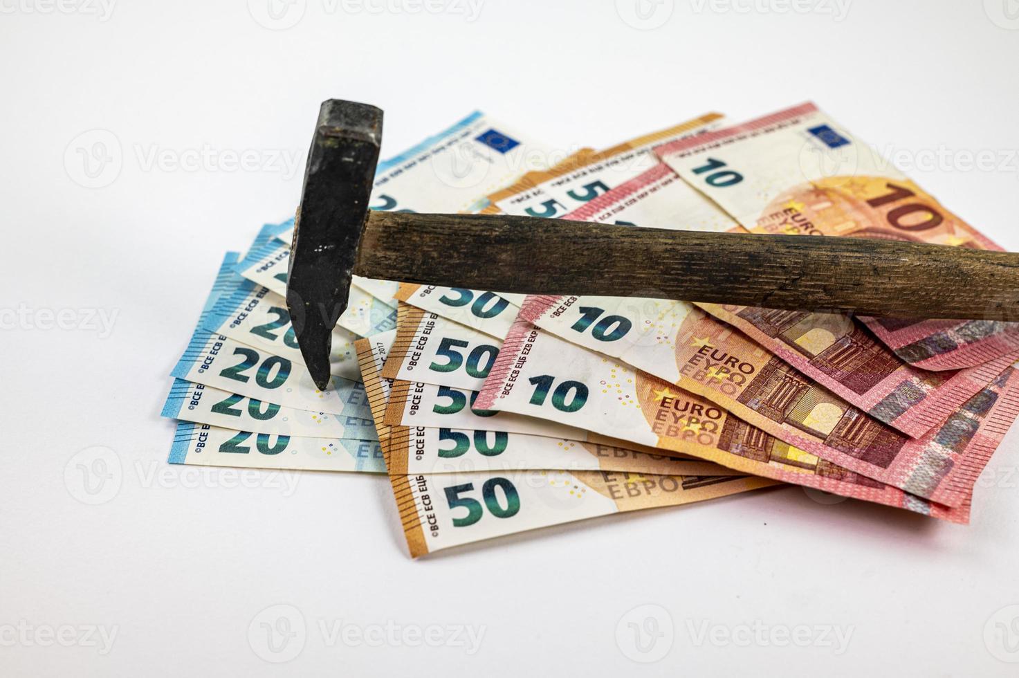 of 10 20 50 euro banknotes with work hammer photo