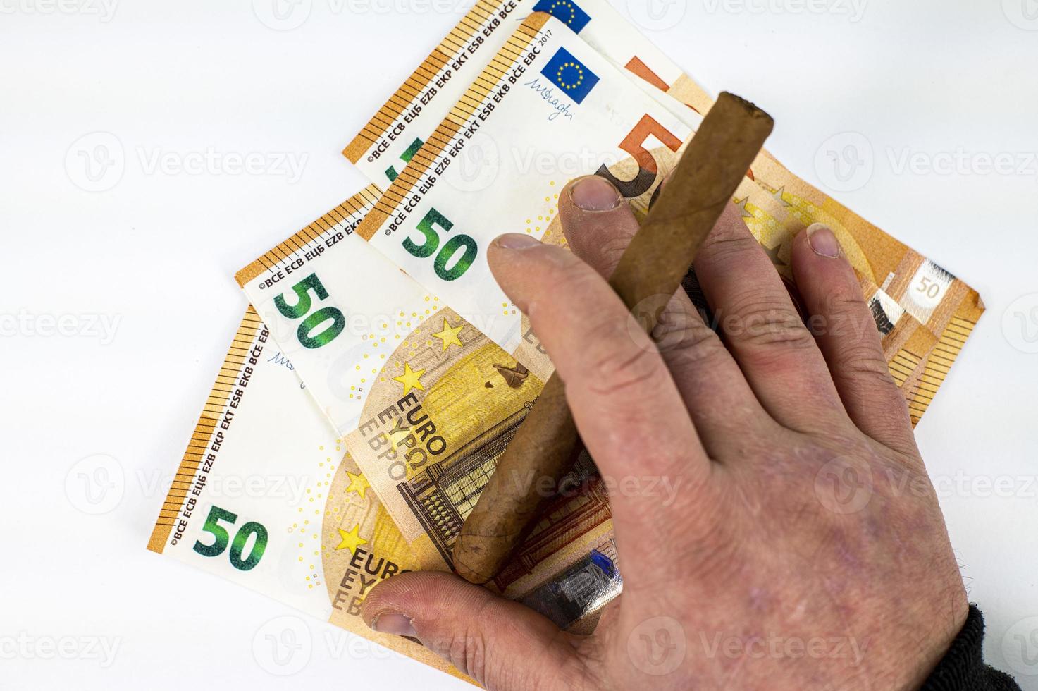 Billetes de 50 euros con la mano del hombre sosteniendo cigarro foto