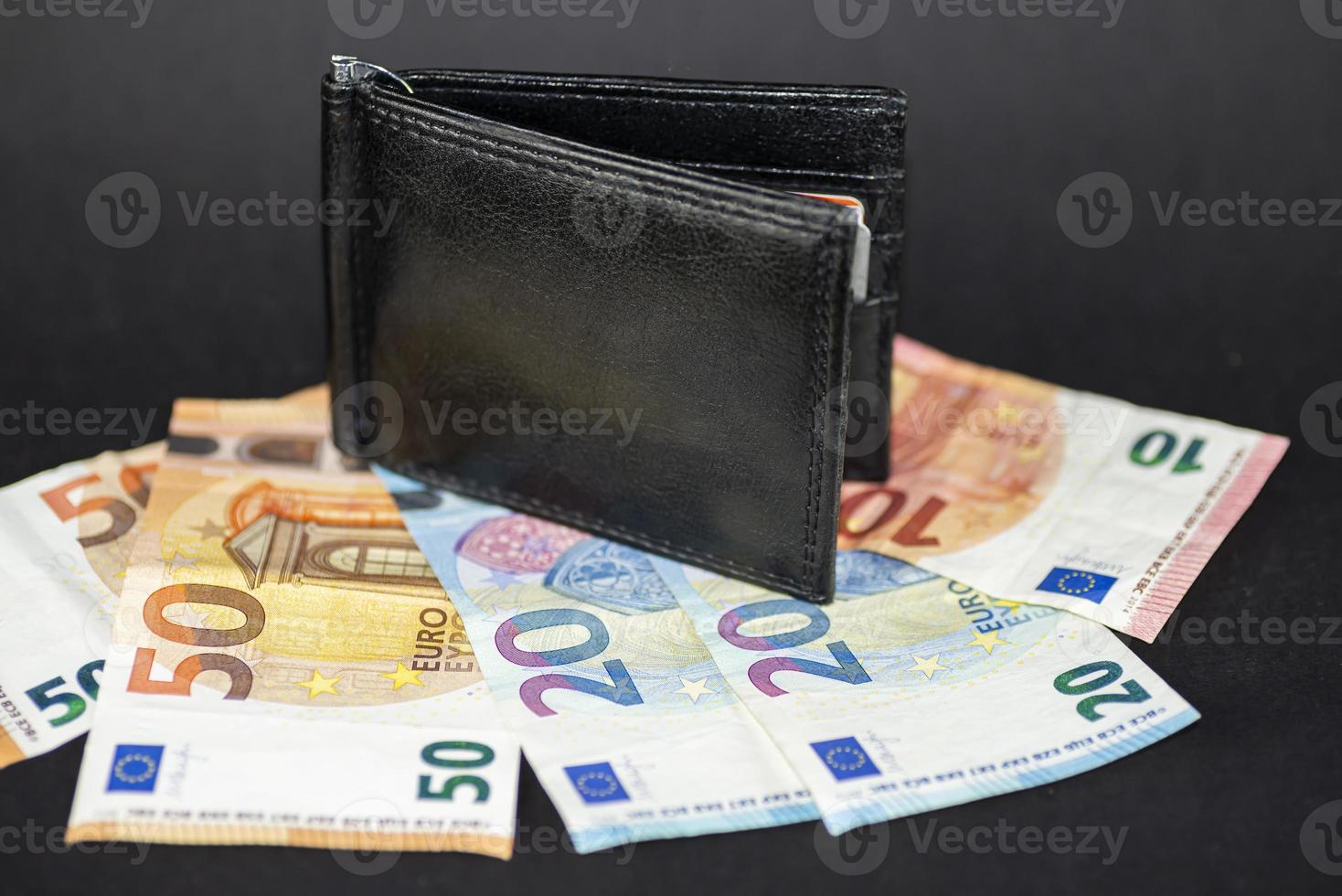 men's wallet on top of banknotes photo